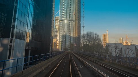 LONDON, circa 2019 - A frantic POV hyperlapse of a train journey along the Canary Wharf Docklands District of London, England, UK on a sunny day
