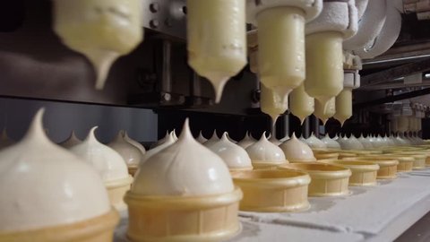 Ice Cream Production Line. Filling of Wafer Cups with Ice Cream. Ice Cream Factory