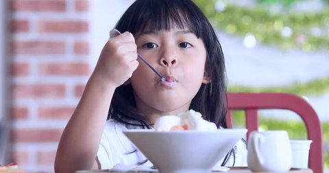 Cute Girl Eating Ice-Cream,little girl with ice cream on colorful background,Asian kid eating ice cream,Kid eating Sweets in cafe