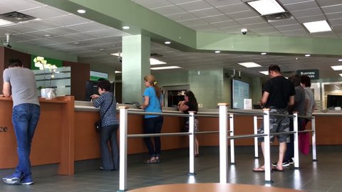 Coquitlam, BC, Canada - May 14, 2018 : Motion of people line up waiting for the service inside TD Bank with 4k resolution