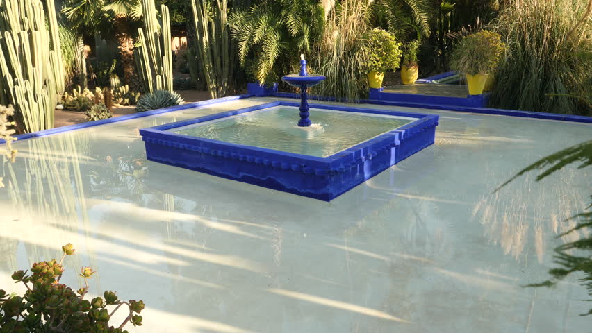 Fountain and tropical trees in Majorelle Gardens. Marrakech, Morocco.