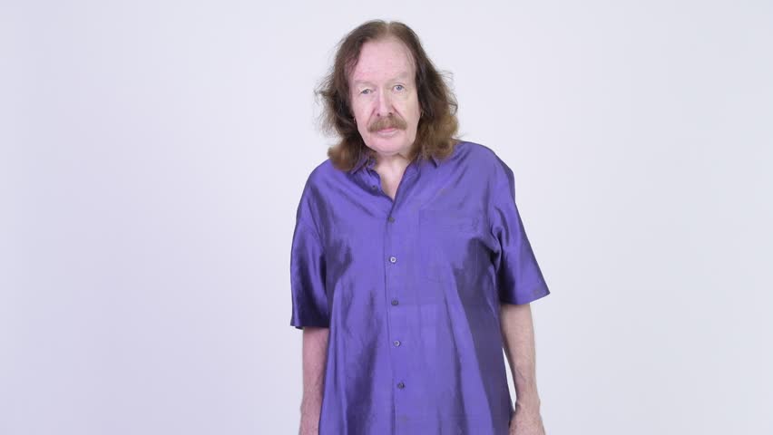 Senior man with purple silky shirt presenting something