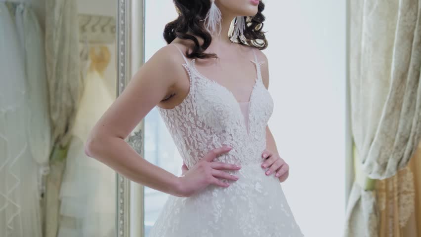 Beautifu bride choosing wedding dress in a wedding salon