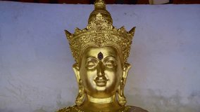 4K video of golden Buddha statue in Phra That Hariphunchai temple, Thailand.