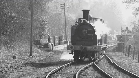 Old style black and white footage of steam train in England UK 4K