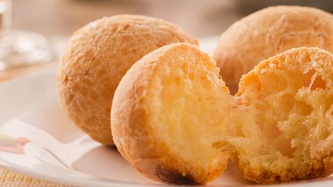 Slide shot Brazilian cheese buns . Table cafe in the morning with cheese bread.4K footage.