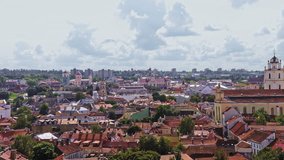 City view of Vilnius from a high point on a warm sunny day. Panning left.