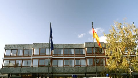 European union and Germany flag waving in front of Federal Constitutional Court building Bundesverfassungsgericht