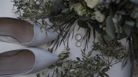 bridal shoes with rings and bridal bouquet.