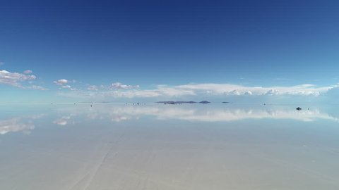 Aerial view of world’s largest salt flat Salar de Uyuni, sky reflection on water surface - landscape panorama of Bolivia from above, South America
