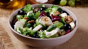 Italian spring salad with goat cheese, grapes and walnuts. Served with croutons. Pour the vinaigrette dressing - Powered by Shutterstock - Get 15% off with code: PIKWIZARD15