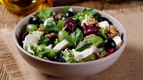 Italian spring salad with goat cheese, grapes and walnuts. Served with croutons. Adding cheese and walnuts. - Powered by Shutterstock - Get 15% off with code: PIKWIZARD15