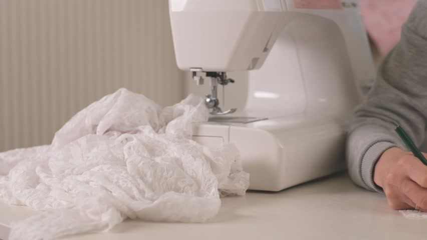 Proffesional seamstress making pettern with pencil