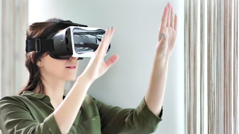 Confident Caucasian woman using modern vr device vision technology immersing at cyberspace