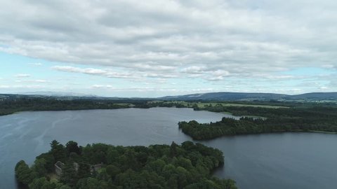 Aerial footage over the ruins of Inchmahome Priory on a tree covered island on the picturesque Lake of Menteith.