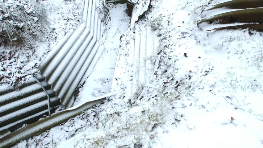 Remains of World War One battlefield (Hooge Crater Museum, Ypres, Belgium) after snowfall