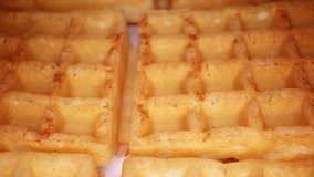 Sweet waffles closeup texture video on rolling rotating looping plate