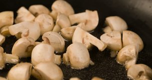 Champignons mushrooms roasting Cooking closeup Macro shot in Pan 4K video