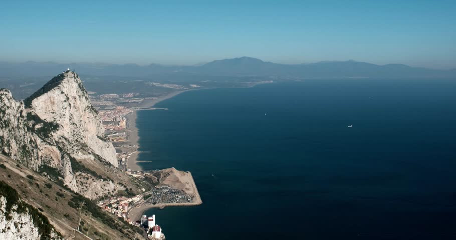 Aerial panoramic view of top of Gibraltar Rock, in Upper Rock Natural Reserve and plane landing at the airport of Gibraltar International Airport. United Kingdom, Europe