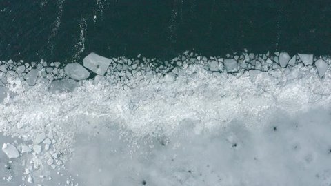 Glacier Lagoon with icebergs from above. Aerial View. Cracked Ice from drone view. Background texture concept. 