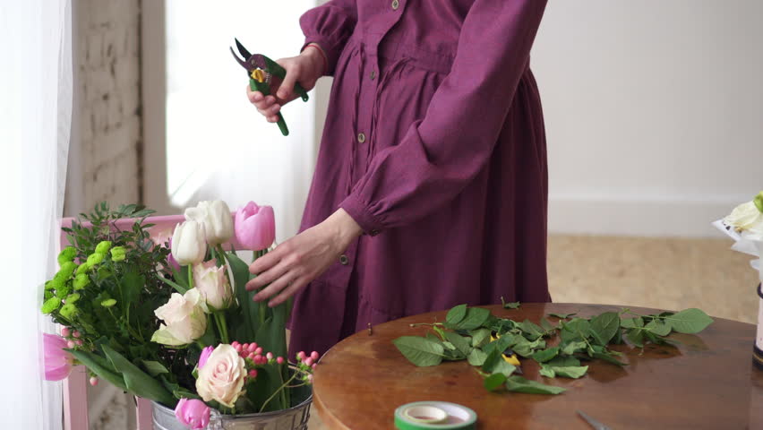 Female florist pruning flower stalk