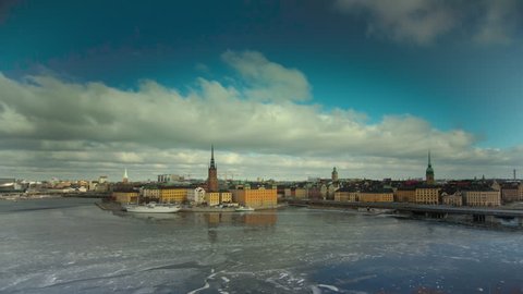 Timelapse view towards Stockholm City Hall. Ice is melting on Lake Malaren