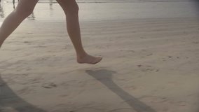 Young runner on the beach at sunset, slow motion clip