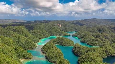 Tropical landscape rainforest hills and azure water in lagoon with clouds. ?oast on the Siargao island, Bucas Grande Island, Sohoton Cove, Philippines. Aerial Drone Timelapse 4K