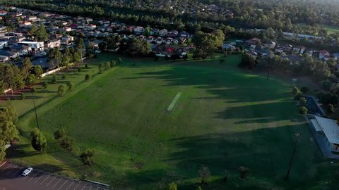 Aerial point of interest shot over a cricket field.