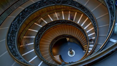 ROME, ITALY - JUNE 9 2018: Timelapse of the modern Bramante spiral stairs of the Vatican Museums, designed by Giuseppe Momo, Rome, Italy. People are walking downstairs.