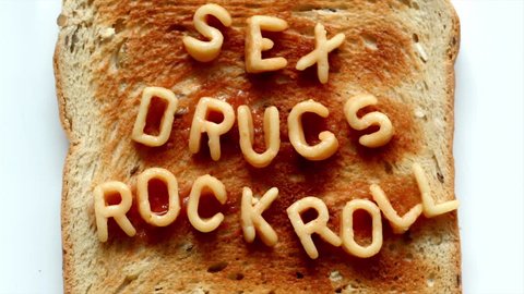 sex drugs rock n roll written with spaghetti pasta letters in tomato sauce on toast