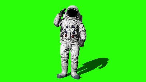 Astronaut walking on the Green Screen and saluting.