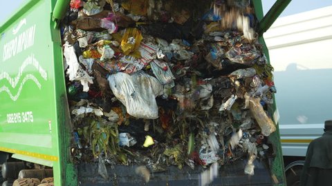 AFRICA,SOUTH AFRICA,CIRCA 2018. 4K close-up view of trash being dumped by a garbage truck at a landfill dump site