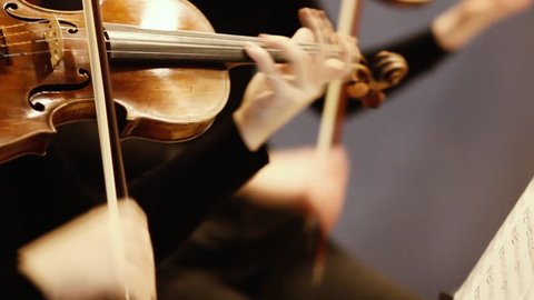 expressive violin playing in an orchestra at an event