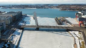 Länsisatamankatu bridge, Helsinki, Finland - 26 February 2019. Aerial view of the city, modern bridge and frozen river