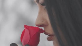Woman smelling red rose flower - Powered by Shutterstock - Get 15% off with code: PIKWIZARD15