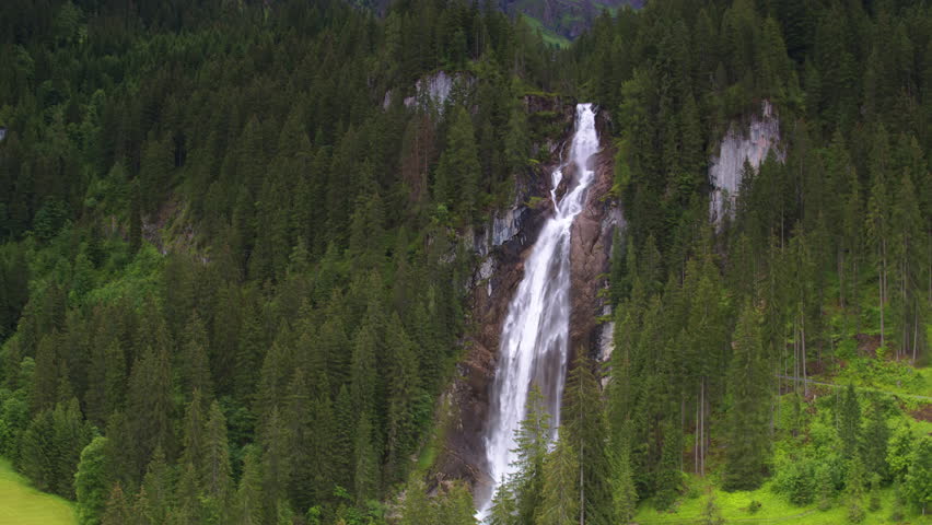 Cinematic aerial shot reversing and revealing Iffiigfall waterfall, Switzerland