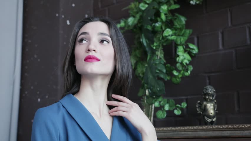 Beautiful brunette girl smiles and puts her finger to her lips, slow motion 1920x1080