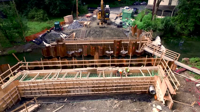 Aerial push in on construction workers building scaffolding for the bridge reconstruction Lancaster County, Pennsylvania Concept: renewal, men, construction, public-private partnership, infrastructure