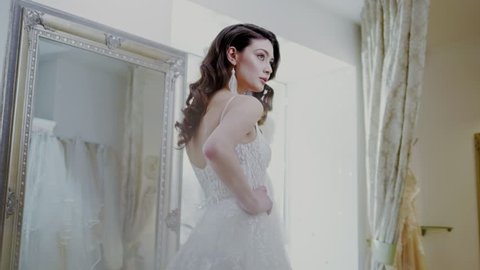 Beautifu bride choosing wedding dress in a wedding salon – Stockvideo