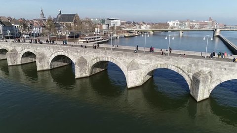 Aerial bird view footage Sint Servaasbrug in English knowns as St. Servatius Bridge is an arched stone footbridge across Meuse River in Maastricht the Netherlands and the oldest one in Holland 4k