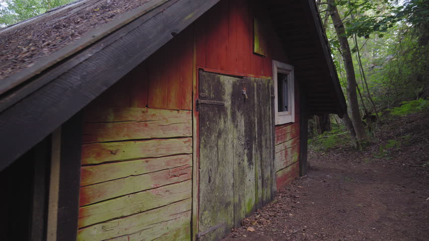 Handheld shot, walking around a old abandoned barn, at the countryside, at a sunny day, at Albysjon, in Tyreso, Sweden