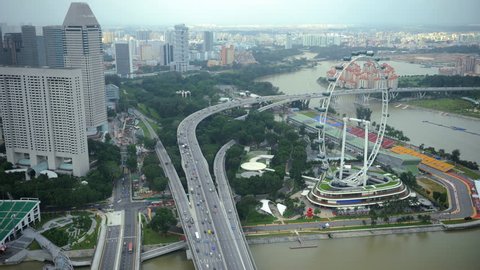 SINGAPORE, SINGAPORE - FEBRUARY 2, 2011 Time Lapse Aerial View of Singapore Flyer and City Skyline with Busy Freeway Day