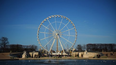 PARIS, FRANCE - MARCH 6, 2010 Time Lapse of Paris City with Tourists People in Amusement Park Ferris Wheel Day