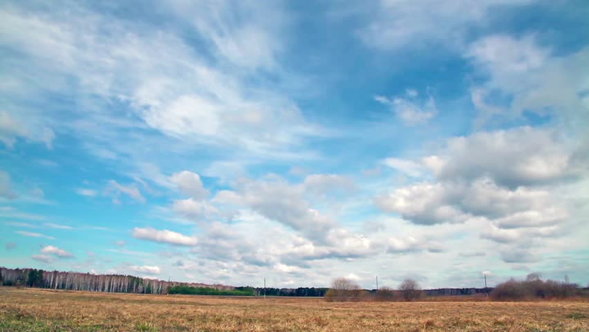 Glitch effect. Clouds over the field. Early Spring
