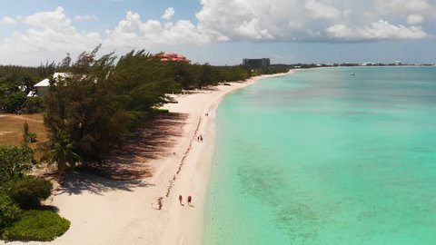 Drone flying near 7 Mile Beach on a sunny day with turquoise waters
