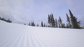 skier makes a turn on the slope, after the snowcat. the corduroy pattern on the snow slope. carving on mountain skiing. close-up of the skier. slow motion video. stock video footage