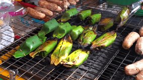 Traditional asian organic sweets made with natural Ingredients, Thai food: 
Thai grilled bananas with sticky rice and Coconut Milk in banana leave.