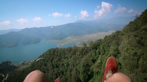 Hanging Legs During Paragliding in Pokhara, Nepal. Adventure and Adrenaline Sport. Tourist Attraction in Himalaya Mountains, Pokhara Lake. Slow Motion.