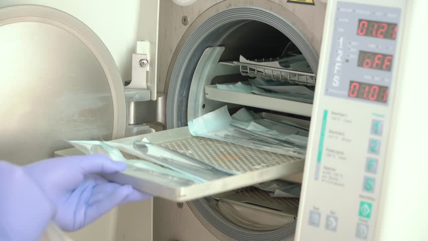 the doctor will put dental instruments for sterilization in a steam autoclave. Sterilization of medical instruments in autoclave. Royalty-Free Stock Footage #1025564747